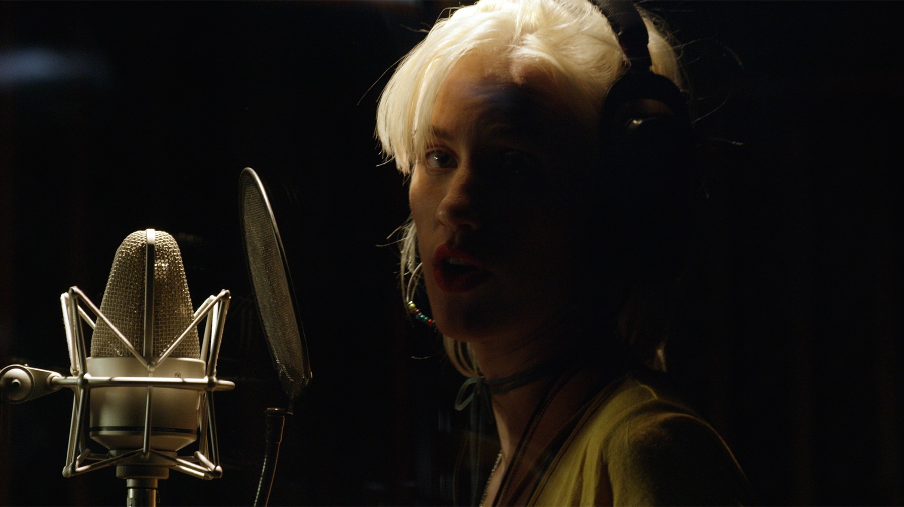 Singer recording into a studio microphone